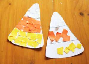 Torn up paper glued in the shape of a candy corn 